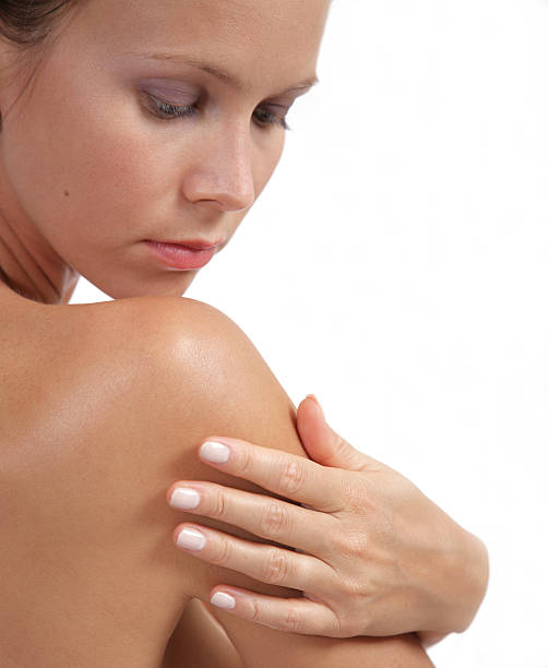 istock young woman applying lotion on her back 172346934
