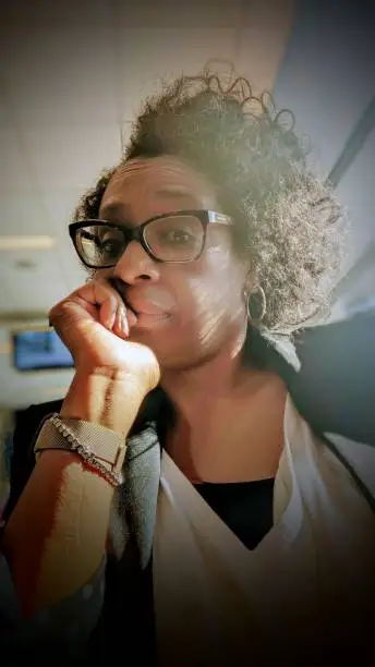 Photo of Selfie of an African American Woman in the Airport with feelings of Frustration