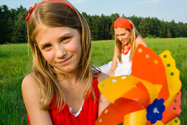 istock Litle girl with paper windmill 172347570