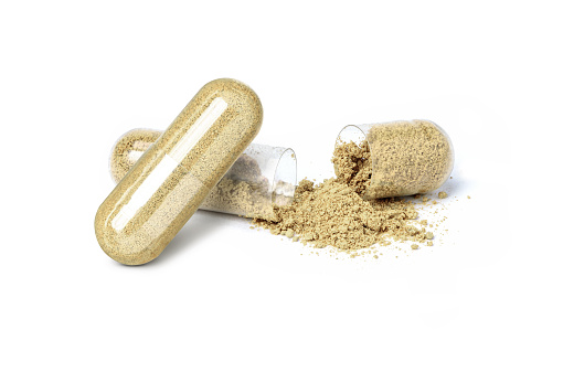 Maca powder and herbal medicine capsule isolated on white background.