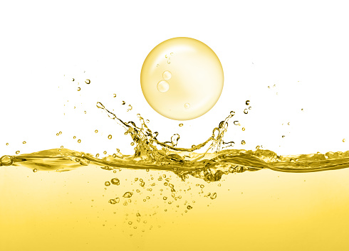 Cooking oil splash with oil drop falling isolated on white background.