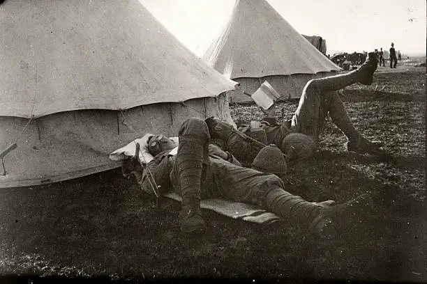 Two British soldiers relaxing outside their tent.