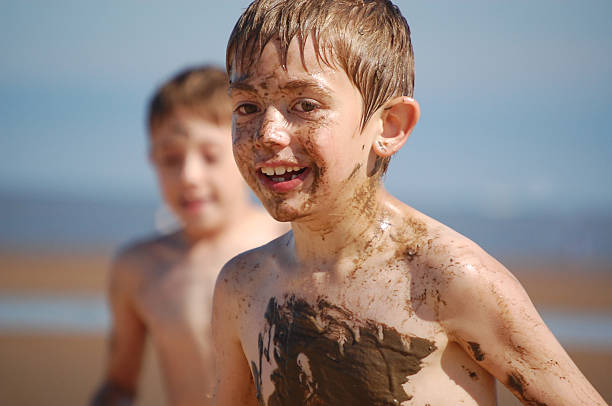 istock Happy child playing in the mud 172348825
