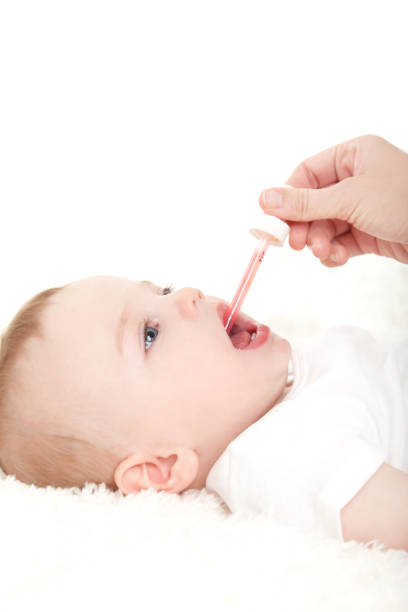 istock Baby boy taking medicine by dropper 172348863