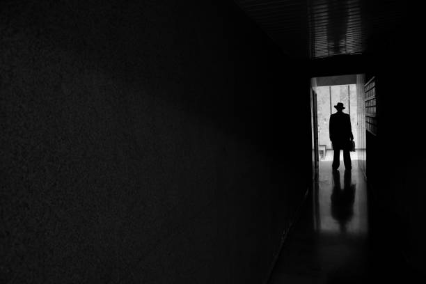 istock Man with hat standing in dark spooky entrence hall 172349245