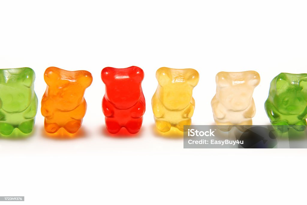 Various colors of gummy bears lined up isolated on white Gummy bear line up isolated on a white background. Gummi Bears Stock Photo