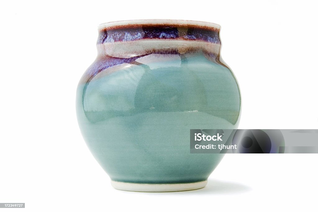 Handmade pottery vase on white A pretty handmade vase on a white background.Other vase imagery: Pottery Stock Photo