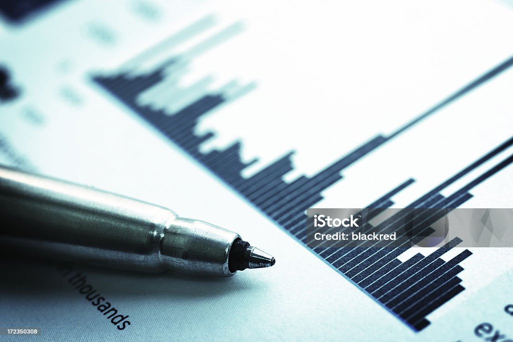 Financial Chart Close up shot of a pen on stock price chart. Analyzing Stock Photo