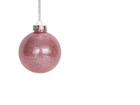 New 2012 white Christmas ornaments and silver glitter snowflakes hanging on a white background.