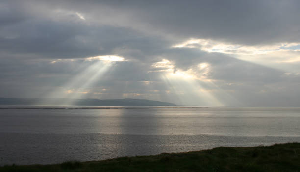 istock bright rays of sunlight against dark sky 172350592