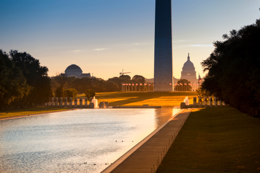 Washington DC Monument and the US Capitol Building and grounds viewed across the reflecting pool from the Lincoln Memorial on The National Mall USA