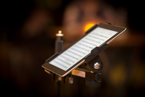 Tablet pc with musical notes on stage