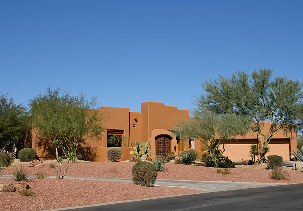 Adobe Model Home Adobe salmon colored home in upscale Arizona neighborhood adobe material stock pictures, royalty-free photos & images