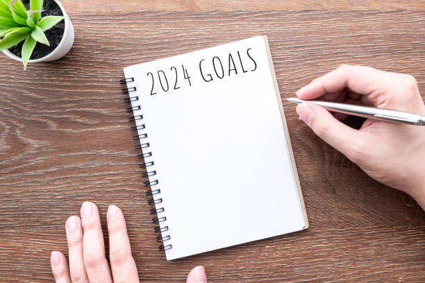 istock Man is writing 2024 goals for new year resolutions plan. 1723512441