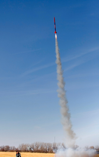 a model rocket club member launches a big smokey rocket