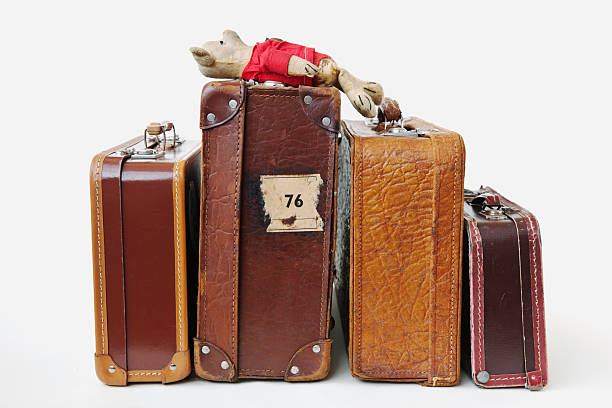 istock Vintage leather suitcases  with lying  worn plush teddy bear. 172351732