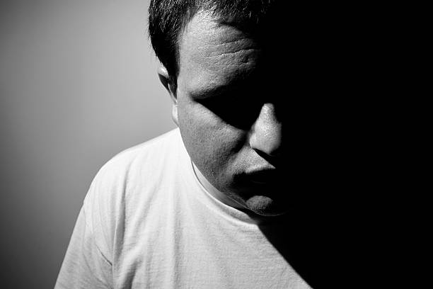 istock Black and white mans face with half in darkness 172351940
