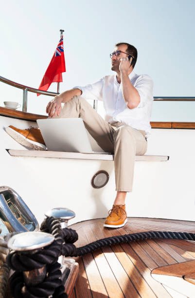 istock Businessman. Luxury yacht. Talking on mobile phone. Reading e-mails. 172352249