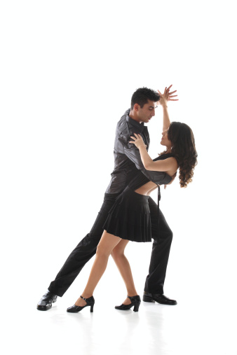 Senior woman dancing with dancing instructor at a dance studio