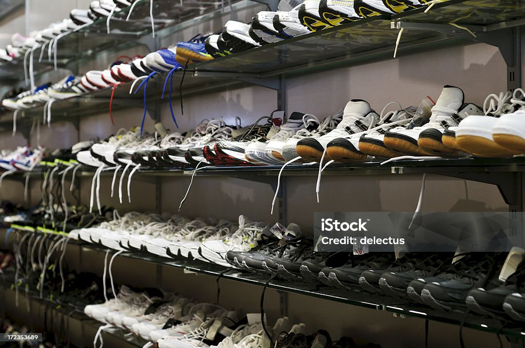 Sport shoes on the shelf Sport shoes in different colors and sizes. Black Color Stock Photo