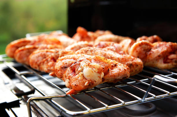 Raw bird on barbecue stock photo