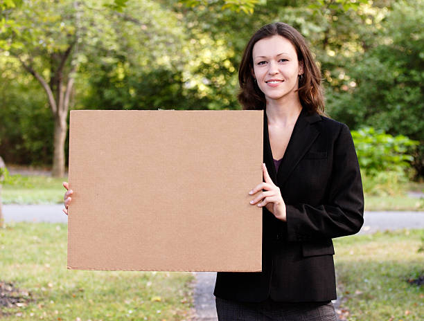 istock Young Woman Holds Cardboard Sign 172354384