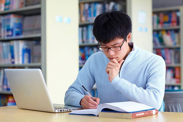 istock A young man studying with laptop and books 172354729