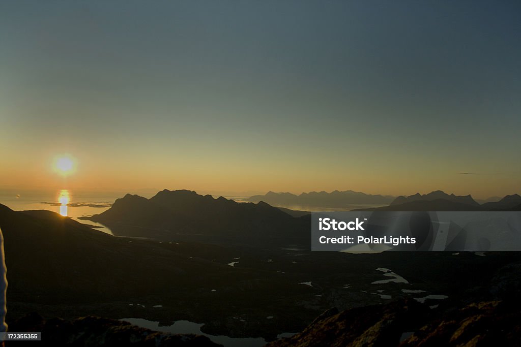 On top of the world Enjoying the midnight sun and beautiful norwegian scenery on top of a mountain at half past midnight. Several hours of walking and climbing is definately worth it.See my other midnight sun images: Achievement Stock Photo