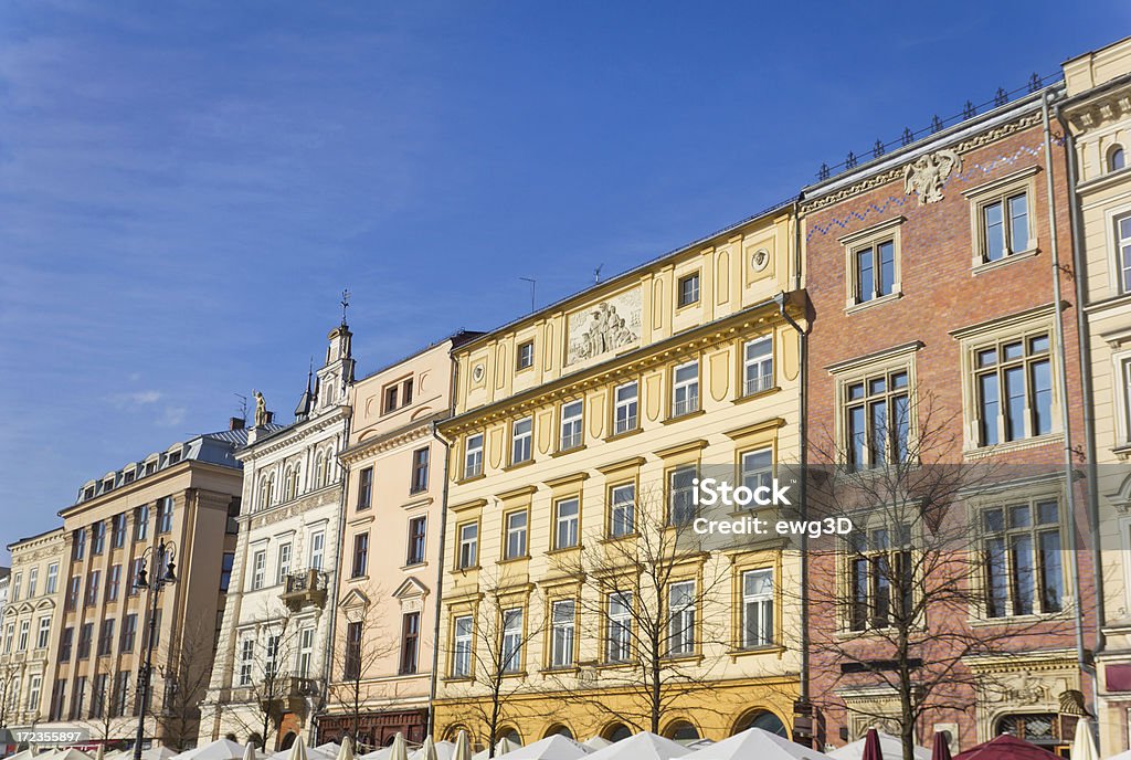 Tenement Houses in Cracow, Poland "Beautiful renovated tenement houses against blue sky on the Market Square in Cracow, Poland. See more CRACOW AND SURROUNDINGS images here:" Apartment Stock Photo