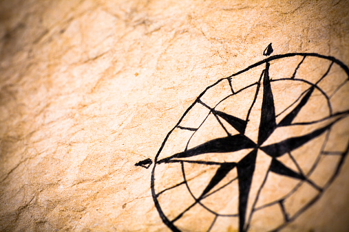 Hand drawn compass on an ancient piece of paper.