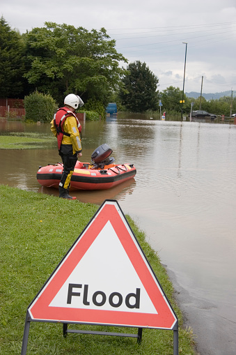 A rescue worker waits by his boat during extreme flooding in Tewkesbury, England. Adobe RGB profile.