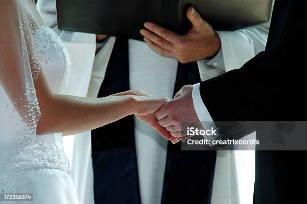 Groom Holding A Brides Hands On Their Wedding Day Stock Photo - Download Image Now - Wedding, Preacher, Priest