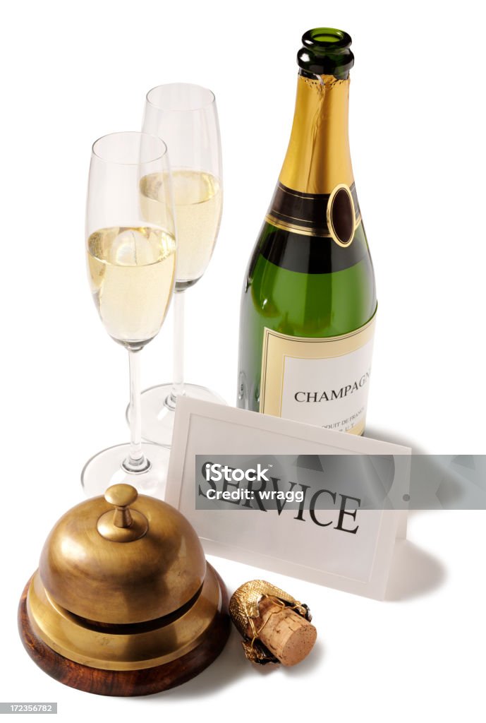 Champagne Service with a Concierge bell and Glasses "Service sign with a champagne cork, concierge bell, champagne glasses and champagne bottle, isolated on white.N.B. champagne label is factious, made by ourselves for this shot.Click on the link below to see more of my business and drink images." Alcohol - Drink Stock Photo