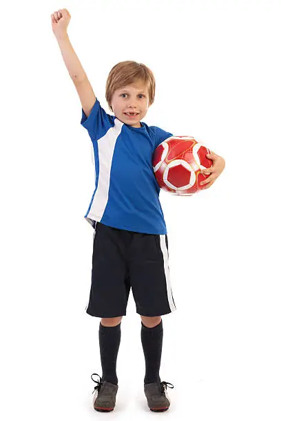 young soccer player raising his arm on white