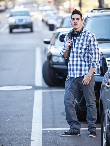 istock Young man crossing city street 172358343