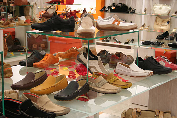 Men's and women's shoes on a shoe rack