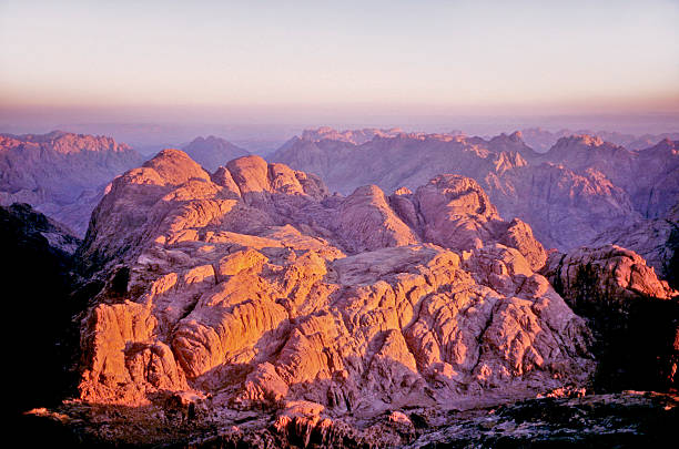 Landscape of Sinai Desert with clear blue sky background and large rocks in foreground.
