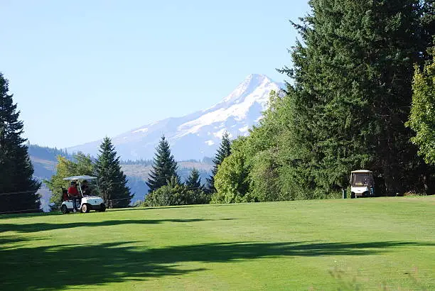 Golfers cruise a course near Mt. Hood, OR.