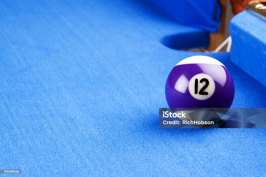 Pool Ball Pool Ball - Number 12 next to pocket Blue Stock Photo