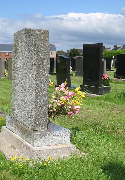 istock Gravestones at the cemetery with flowers 172359570