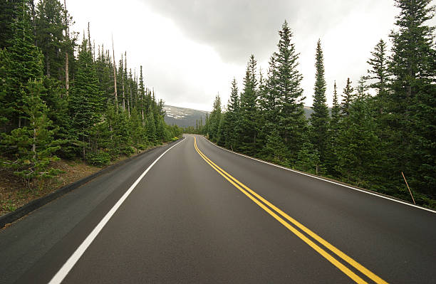 Smooth New Road Through Forest and Mountains stock photo