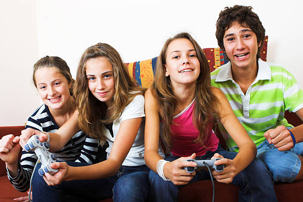 istock Four teenagers playing video games together 172360018