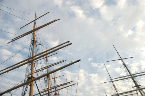 Tall ship masts and rigging soar into the sky