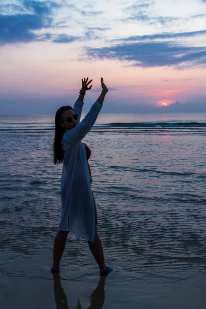 istock Woman pretty with bikini and silhouette on beach 1723603872