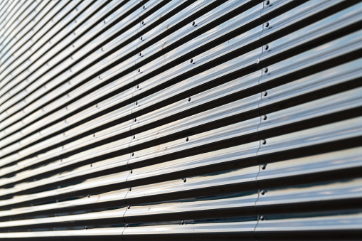 Gray corrugated metal wall up close, abstract, background in Minnesota, USA.