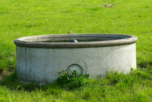 Concrete Water Tank in field