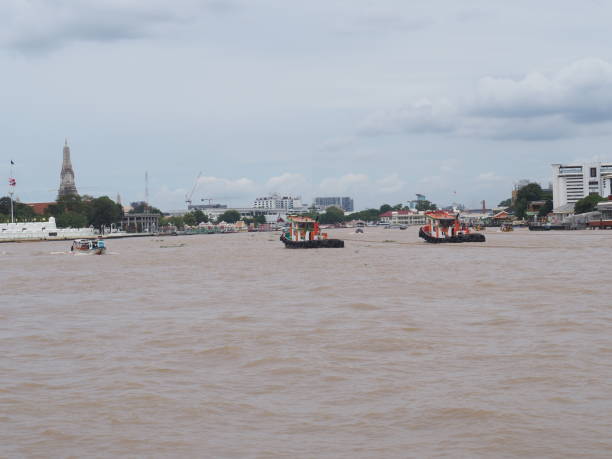 istock River, silver gray boats and rivers, gray, black, brown, blue sky, white clouds 1723614103