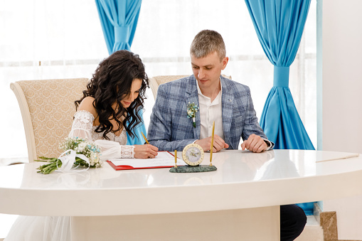 Bride write on registration of Marriage, Woman signing a marriage Contract, close-up