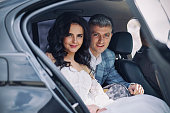 Portrait of a happy newlywed couple in a car