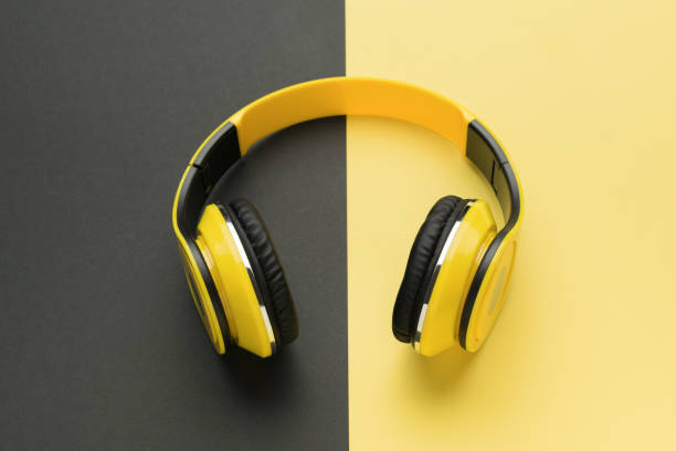 istock Yellow-black headphones on a yellow-black background. 1723615440